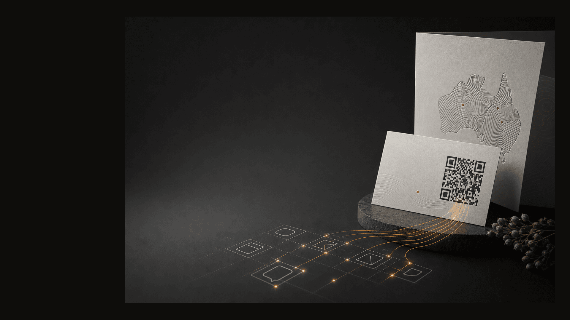 Printed business cards and collateral with a QR code connecting to agent workflows on a dark graphite surface.